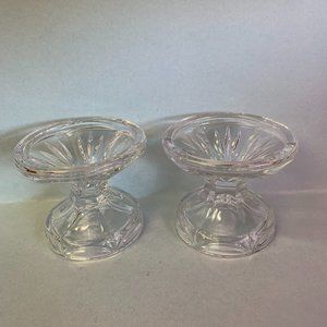 Set of two clear crystal candleholders.